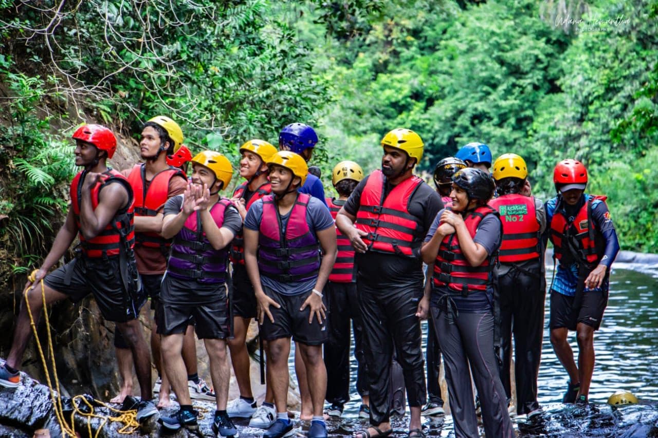 An Xclusive Adventures guide running a safety briefing for a group lined up on the rocks at Kitulgala before entering the water