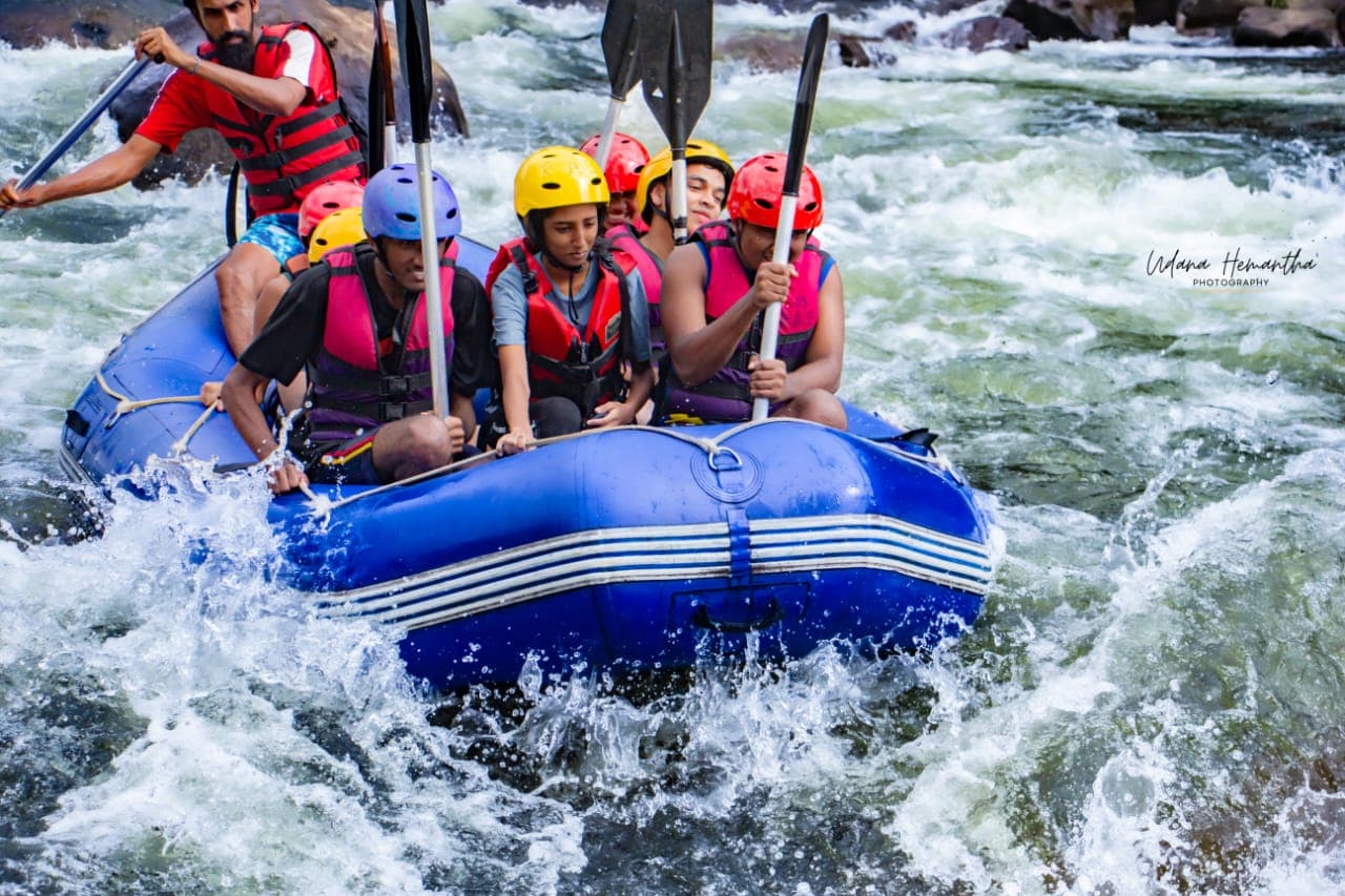 A raft crew paddling in time together under their guide's call on the Kelani River at Kitulgala