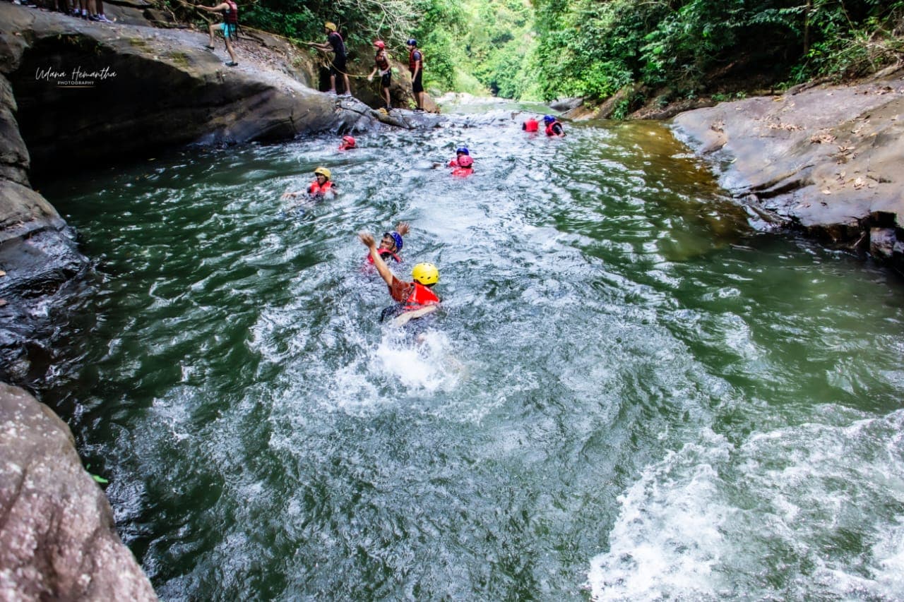 A group making its way down a rainforest gorge stream together on a Kitulgala canyoning route